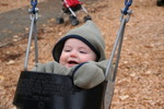 Bundle of baby in swing