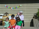 Grandmother Lumpkin with her 4 great grandchildren. Vern (16 months), Alden 5, Georgia, 3 and Will in her arms