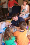 Somehow the kids got the idea to bury Scott in wrapping paper.